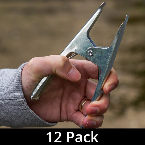 A hand holding one of the heavy duty spring clamps with a label indicating '12 Pack'.
