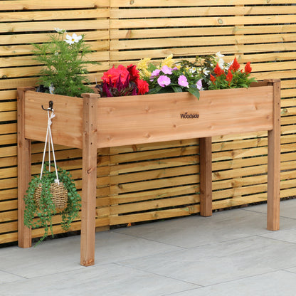 Woodside raised wooden garden bed planter with plants and vegetables, ideal for growing herbs and vegetables in a home garden.