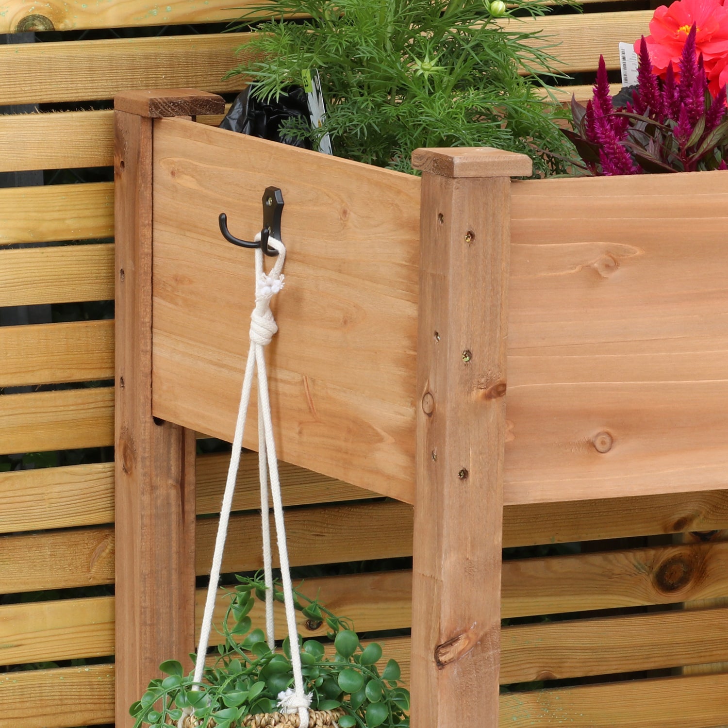Woodside raised wooden garden bed planter with plants and vegetables, ideal for growing herbs and vegetables in a home garden.