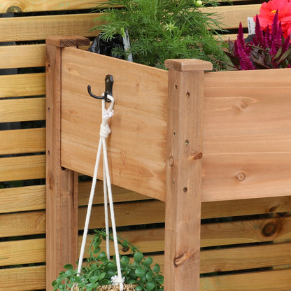 Woodside raised wooden garden bed planter with plants and vegetables, ideal for growing herbs and vegetables in a home garden.