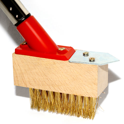 Cleaning brush with red handle and wooden base on a white background