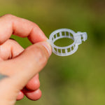 Pack of 200 Woodside tomato plant clips for garden trellis and cable support, ideal for securing plant stems.