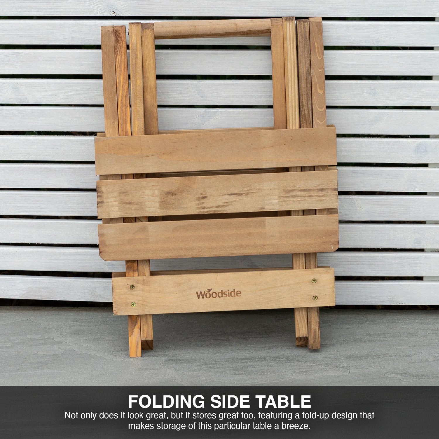 Wooden folding side table with 'Woodside' branding against a slatted wall background.