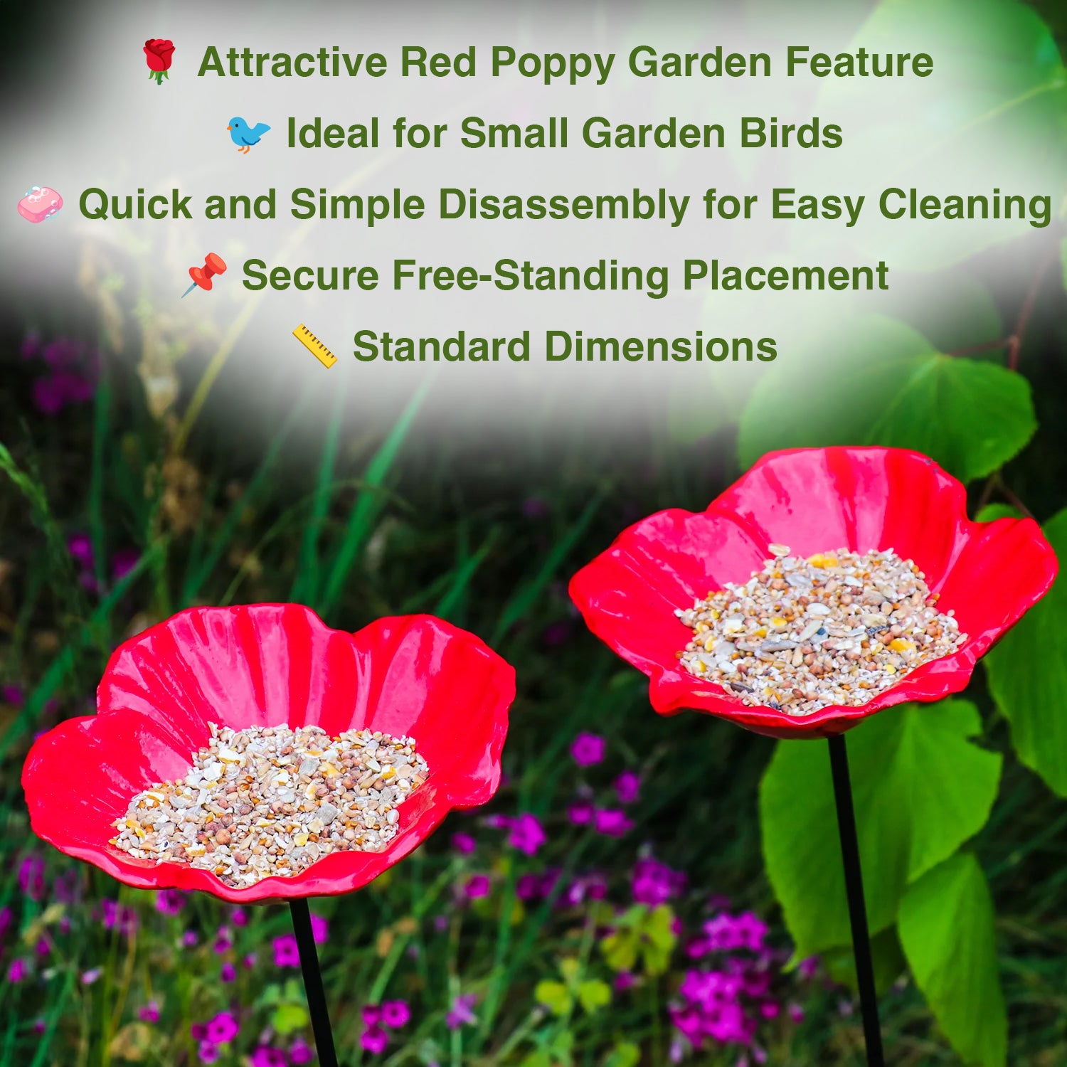 Two red flower-shaped bird feeders with seeds on a garden background.