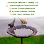 Decorative bird bath with birds on a blurred garden background